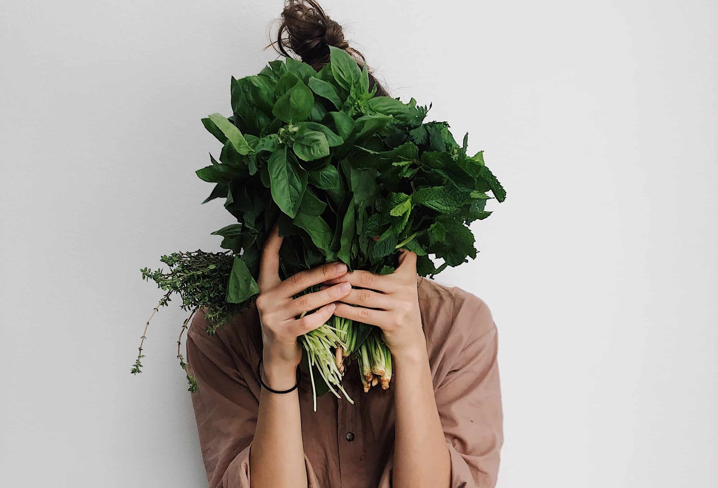 person-holding-green-vegetables