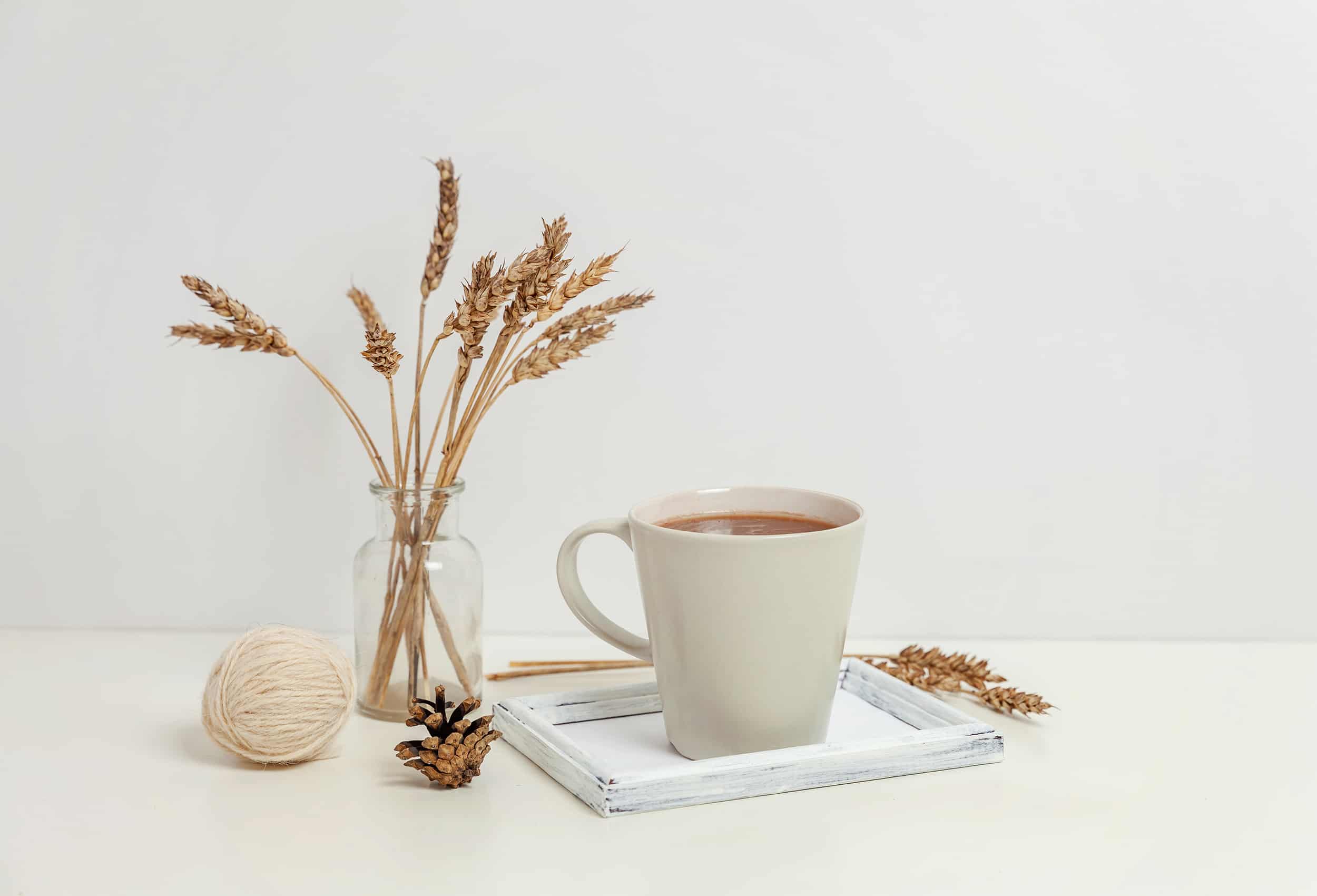 Natural-eco-home-decor-with-cup-coffee-and-candle-on-wooden-tray