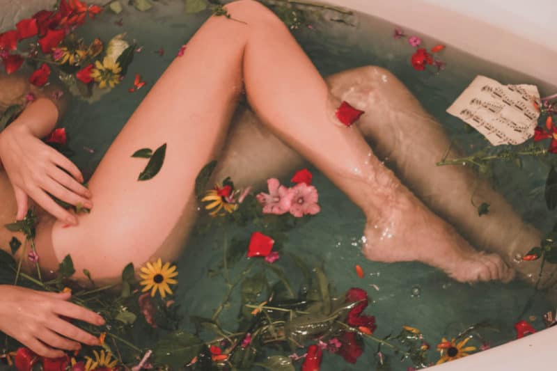 woman-bathing-with-flowers-and-herbs