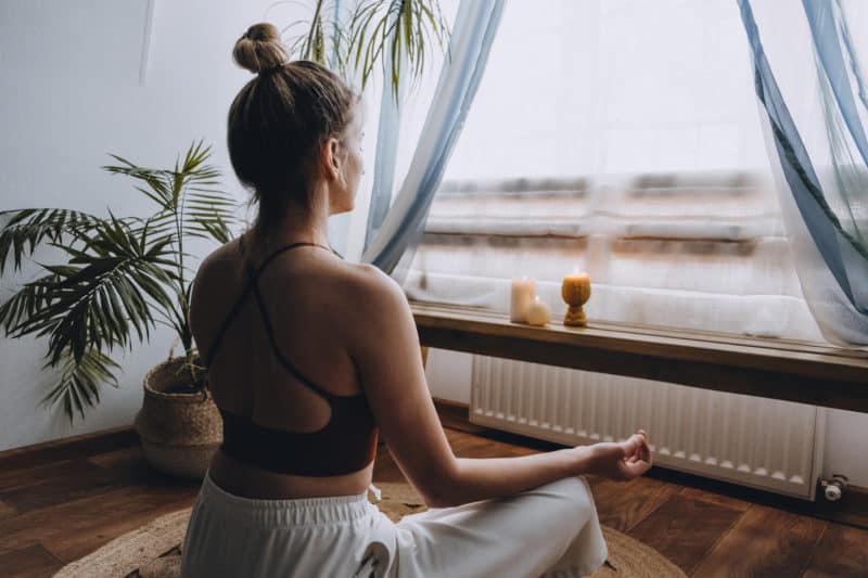 woman-facing-window-meditating