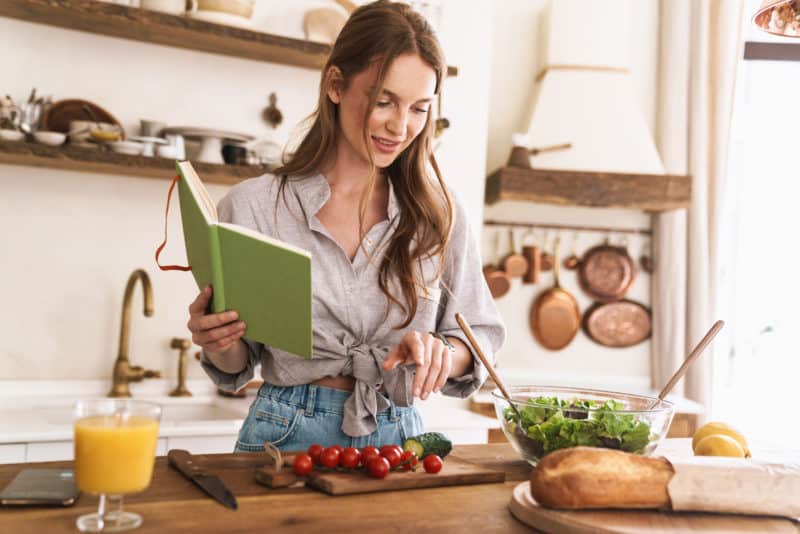 woman-looking-at-cookbook-cooking