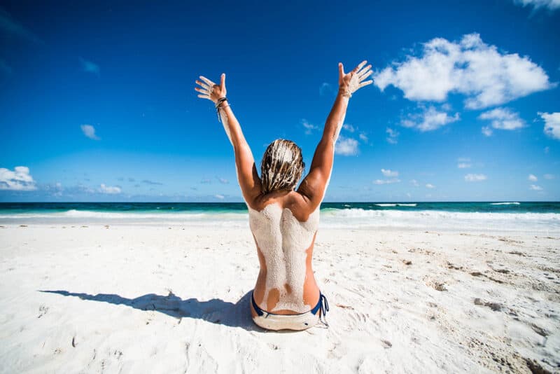 woman-feeling-successful-on-the-beach-arms-in-the-air