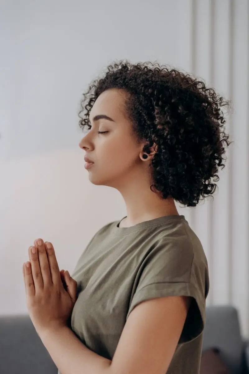 woman-curly-hair-praying-imagining-visualizing-manifestation