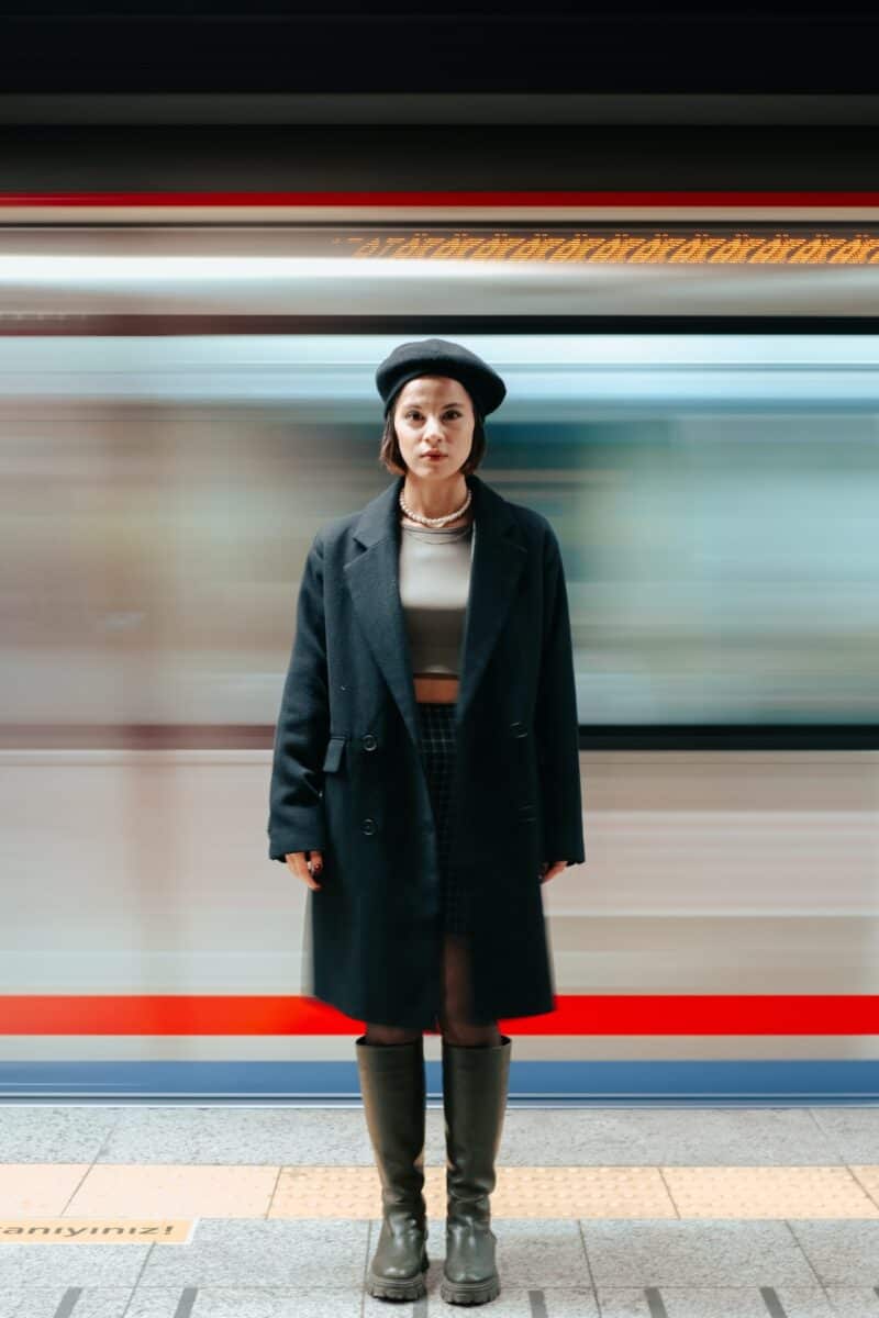 woman-french-beret-standing-in-front-of-moving-subway-fast-forward