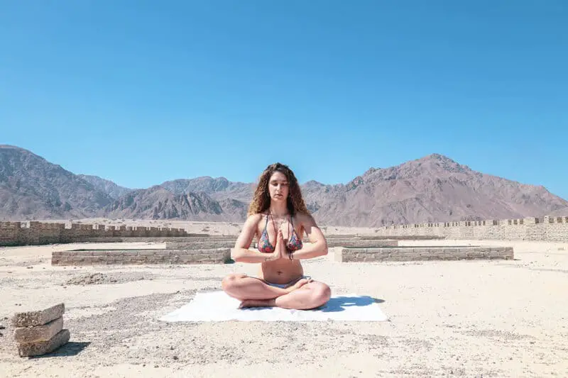woman-in-bathing-suit-in-the-desert-meditating-prayer-hands-I-AM