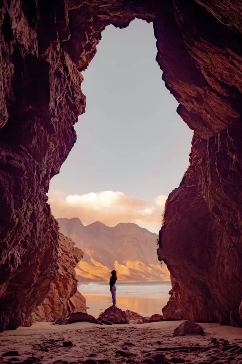 woman-standing-red-rock-cave