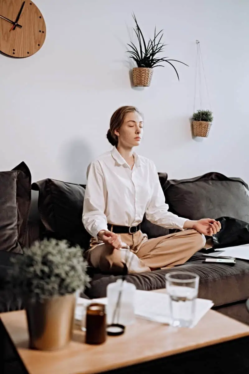 woman-collared-shirt-meditating-breathing-technique-manifestation