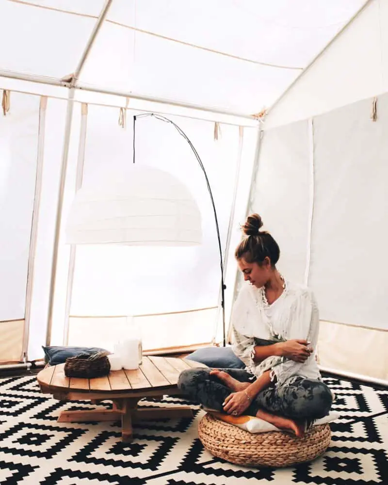 woman-on-meditation-pillow-in-a-tent