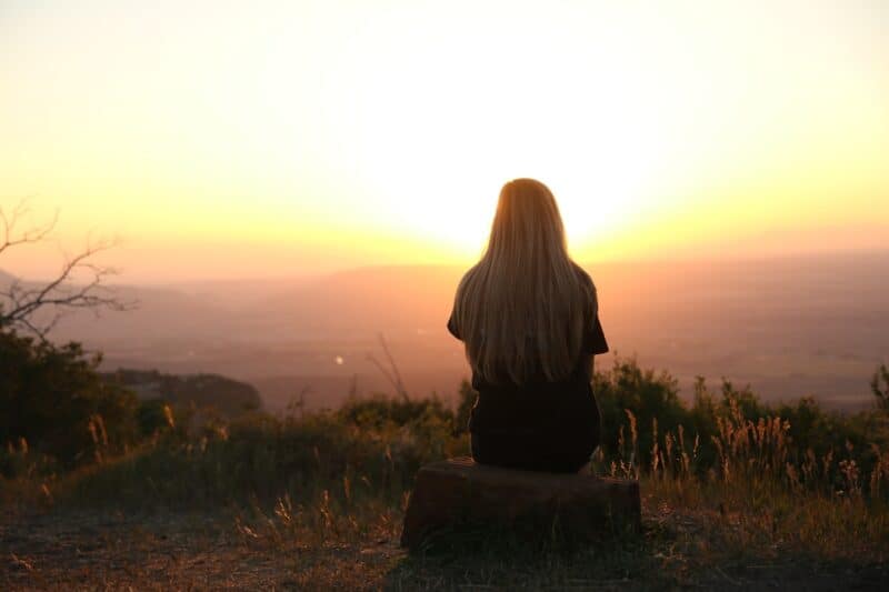 girl-with-long-hair-in-nature-looking-at-sunrise