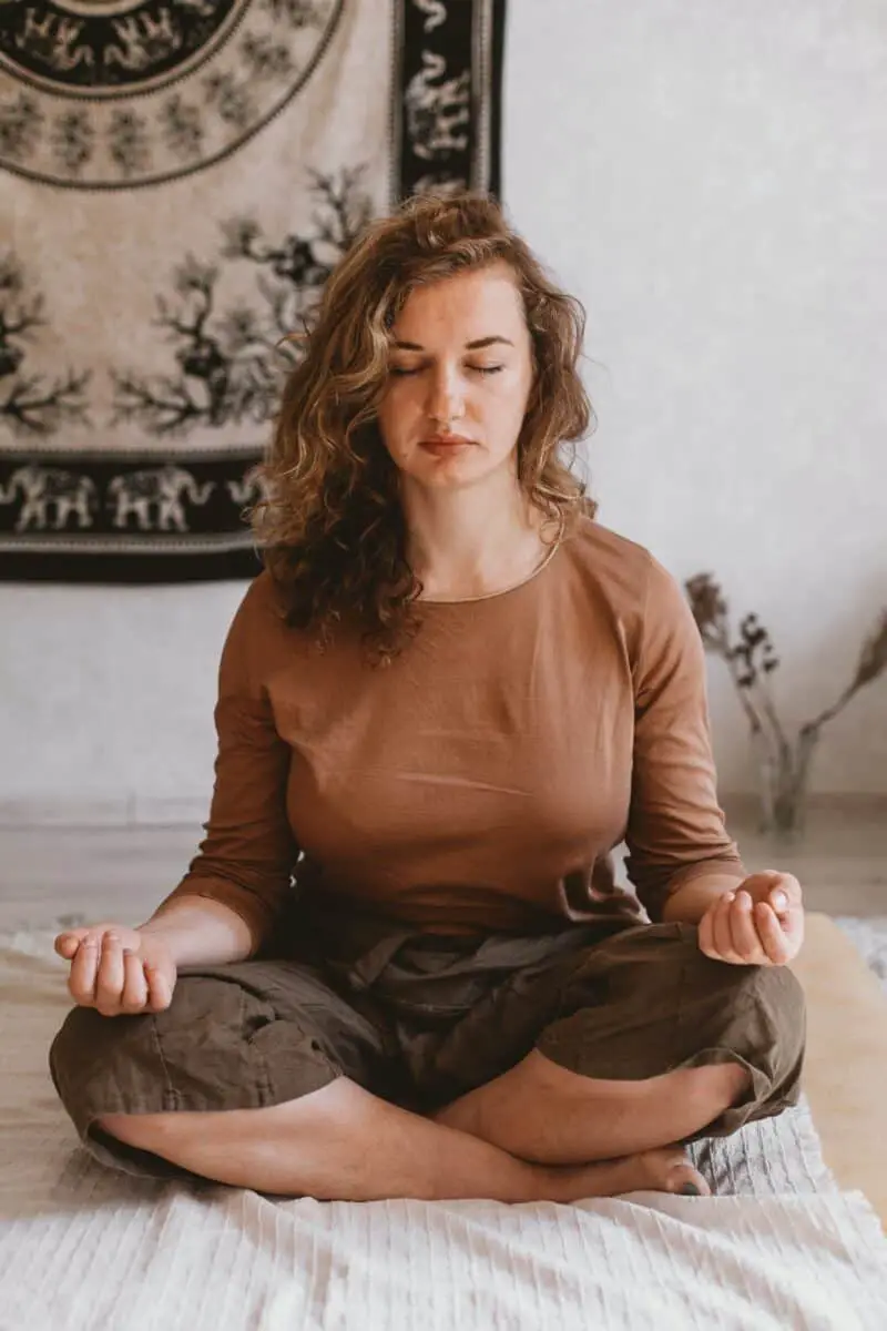 woman-meditating-in-brown