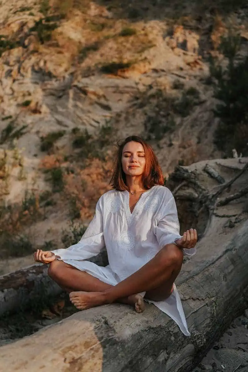 self-healing-techniques-woman-in white-meditating-in-nature