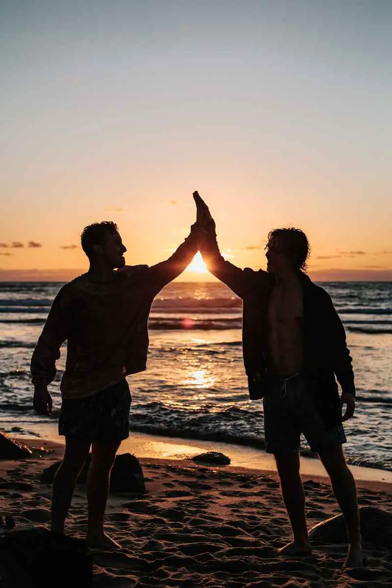 signs-your-manifestation-is-close-two-people-hi-fiving-on-beach