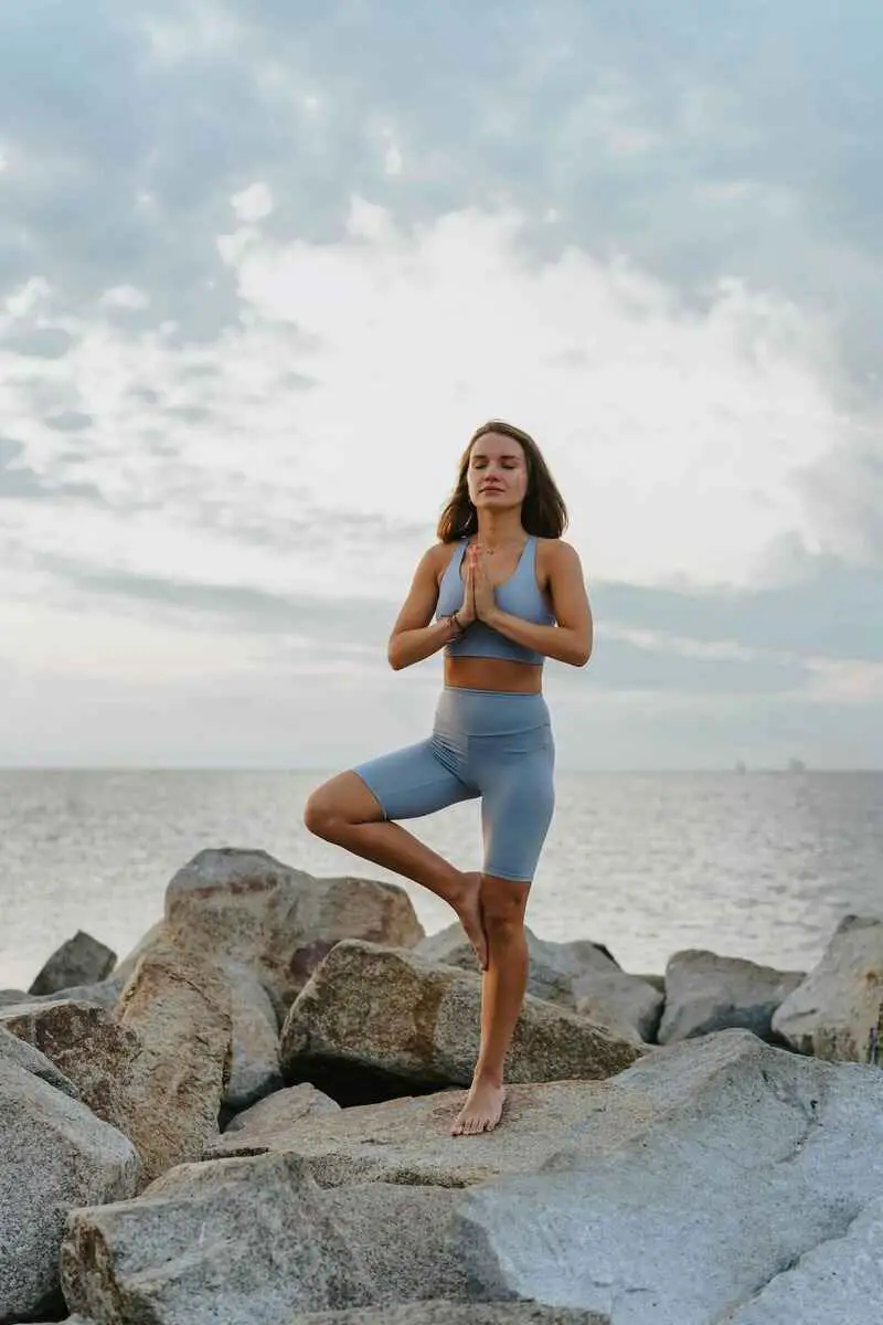 signs-your-manifestation-is-working-woman-in-blue-doing-yoga-and-praying
